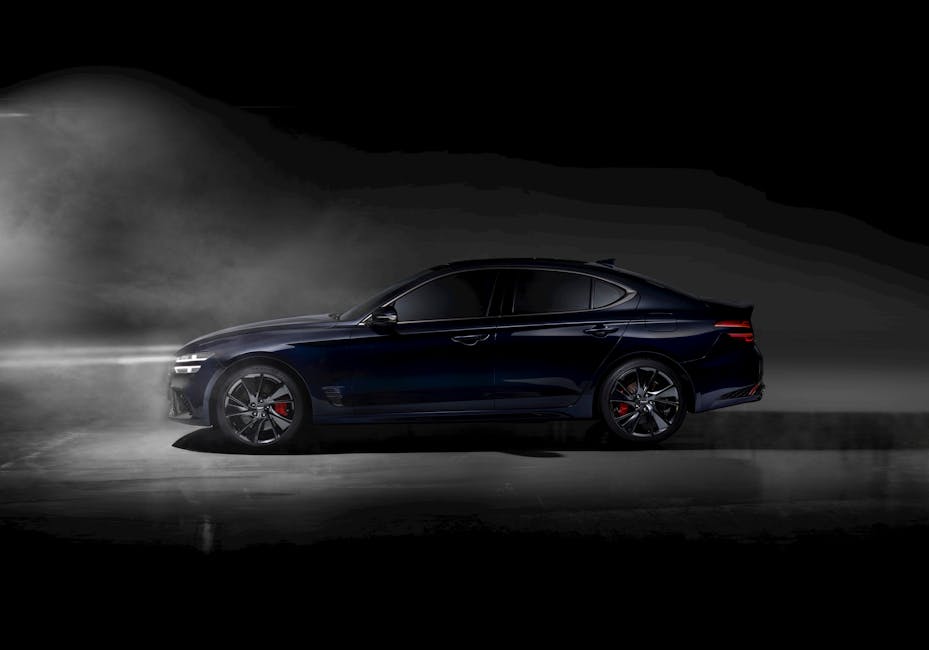 Luxury sedan with red brake calipers under dramatic lighting and smoke effect, showcasing elegance.